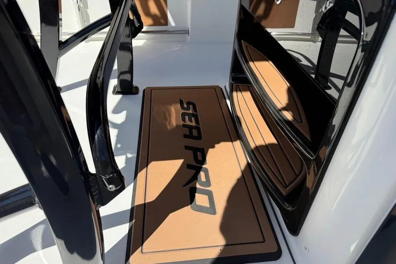 Slide: The Image of 2026 Sea Pro 242 Center Console boat interior with branded floor mat. - 15