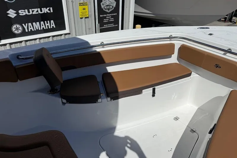 Slide: The Image of 2026 Sea Pro 242 Center Console boat interior with brown seating and branded signage. - 16