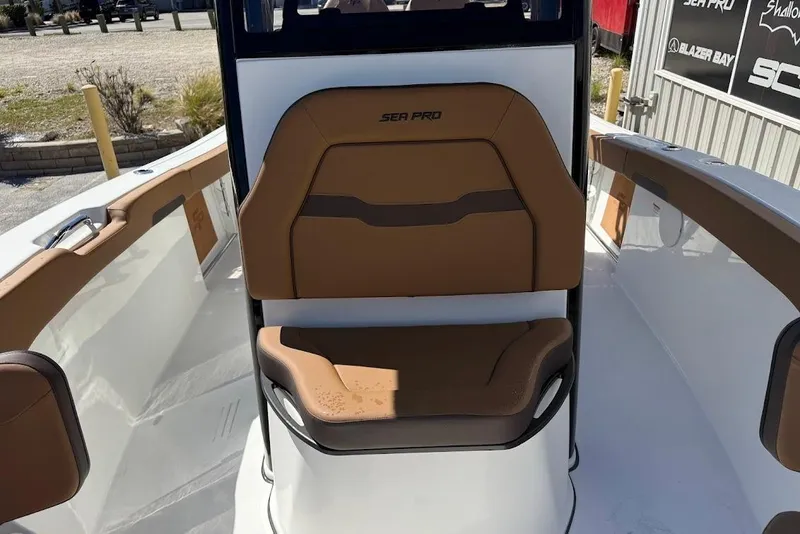 Slide: The Image of 2026 Sea Pro 242 Center Console boat interior with tan seating and sleek design. - 19