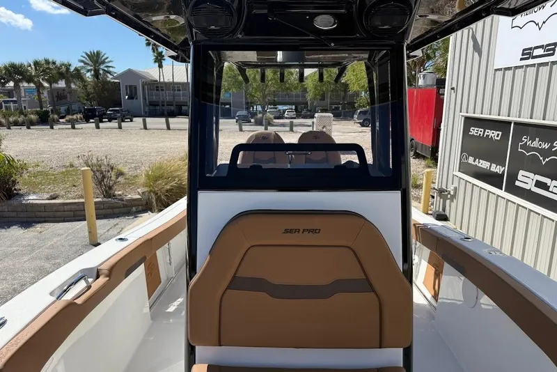 Slide: The Image of 2026 Sea Pro 242 Center Console boat interior with tan seating and console view. - 20