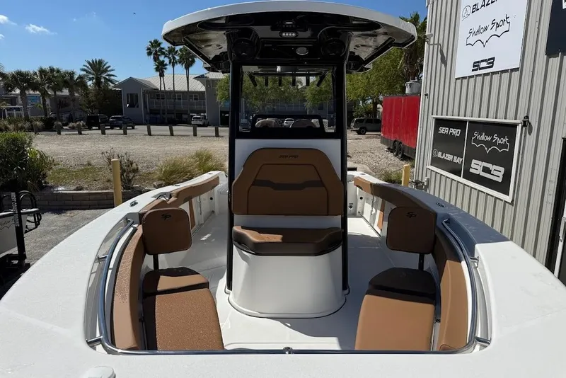 Slide: The Image of 2026 Sea Pro 242 Center Console boat with tan seating, docked outdoors. - 4