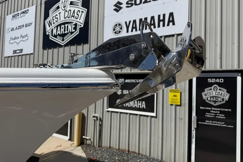 Slide: The Image of Bow of 2026 Sea Pro 242 Center Console with anchor, West Coast Marine signage in background. - 5