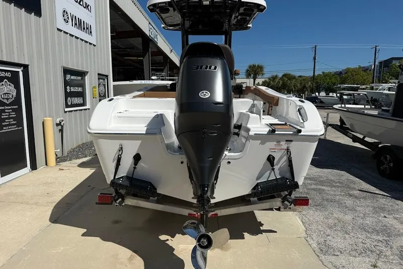 Slide: The Image of 2026 Sea Pro 242 Center Console boat with powerful outboard motor at a dealership. - 7