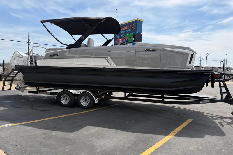 Slide: The Image of 2025 Balise HORIZON 24C pontoon boat on trailer, parked outdoors under clear sky. - 10