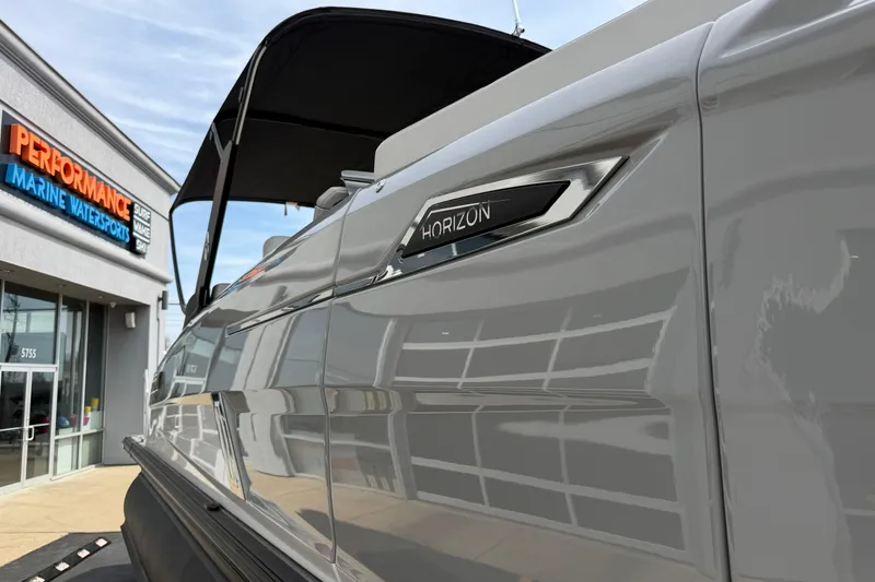 Slide: The Image of 2025 Balise HORIZON 24C boat displayed at Performance Marine Watersports dealership. - 13