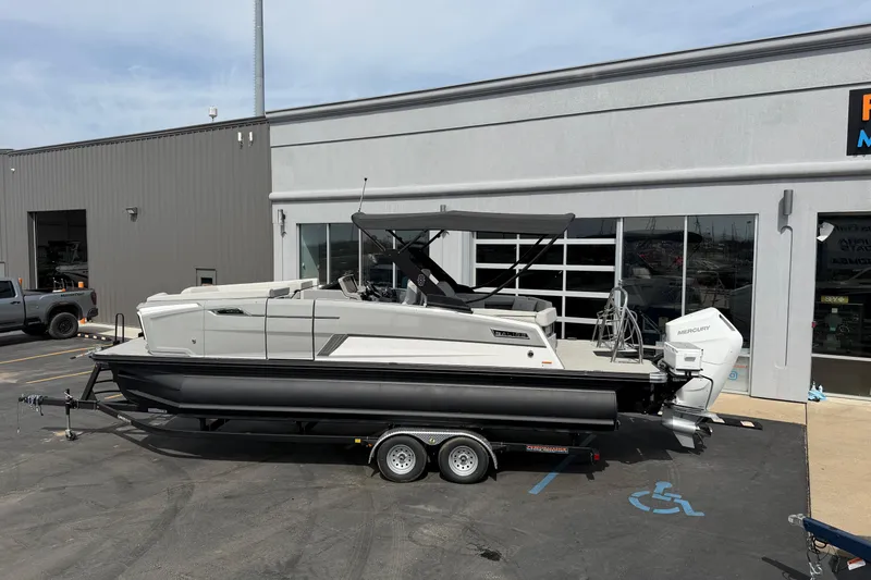 Slide: The Image of 2025 Balise HORIZON 24C boat on trailer outside dealership, featuring sleek design and Mercury engine. - 3