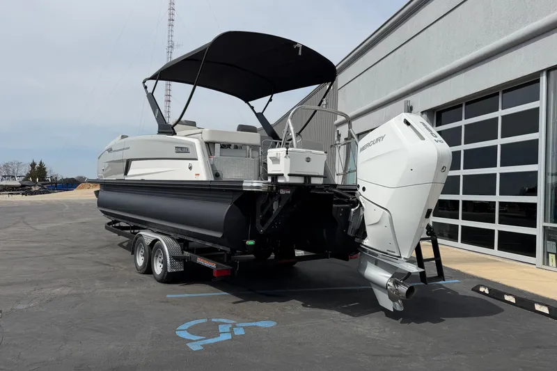 Slide: The Image of 2025 Balise HORIZON 24C boat with Mercury engine on trailer, parked near a building. - 4