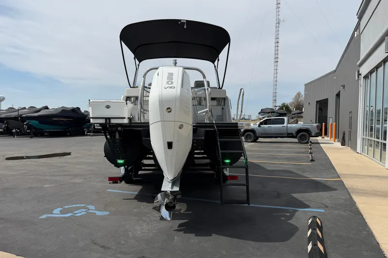 Slide: The Image of 2025 Balise HORIZON 24C boat with outboard motor in a parking lot. - 7