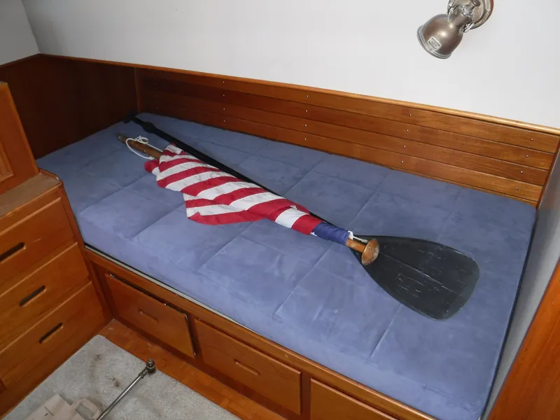 Slide: The Image of Interior of a 1989 Grand Banks 36 Classic yacht with blue bed and paddle. - 13