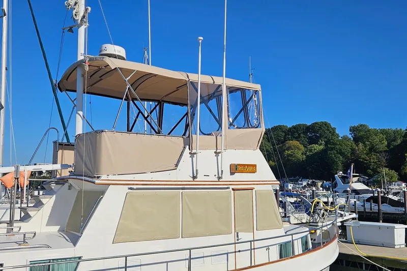 Slide: The Image of 1989 Grand Banks 36 Classic yacht docked at marina under clear blue sky. - 2