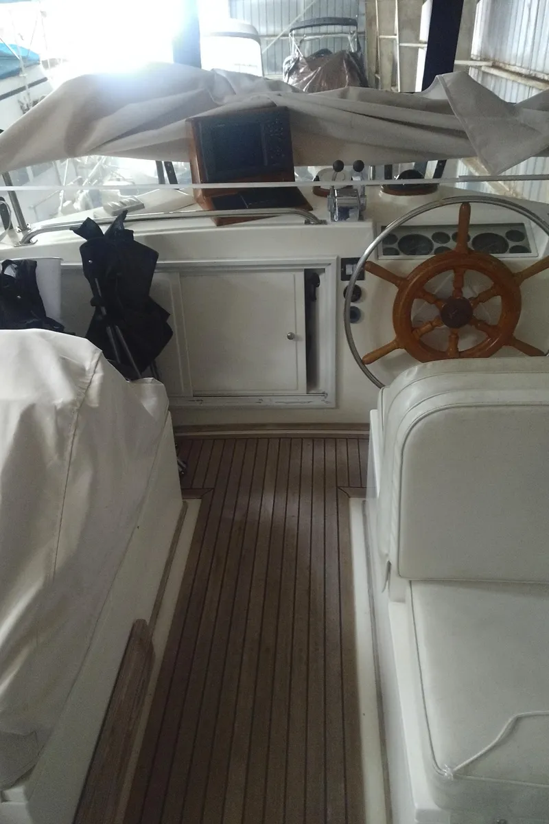 Slide: The Image of Interior of a 1989 Grand Banks 36 Classic yacht with wooden steering wheel. - 26