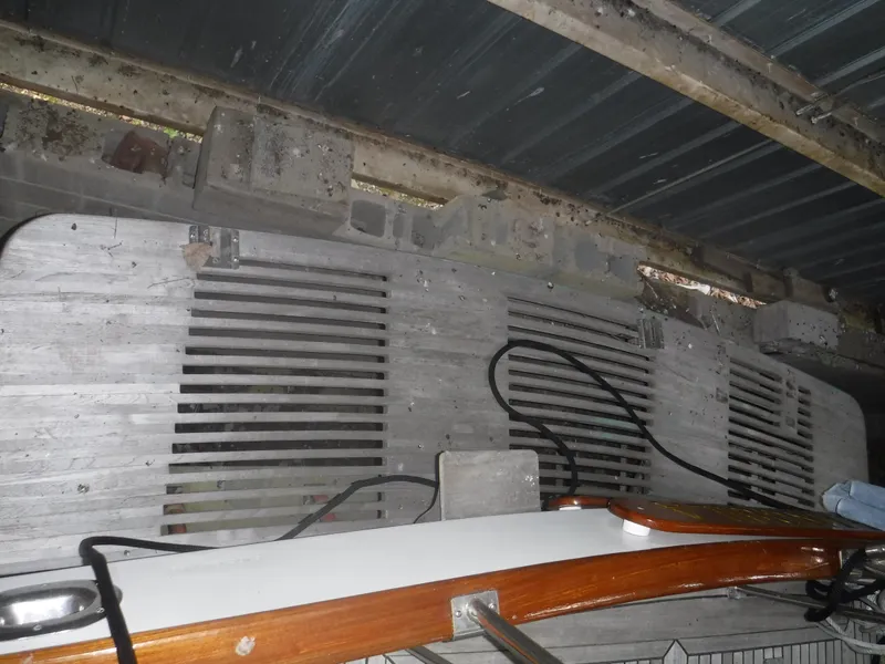 Slide: The Image of Rear view of a 1989 Grand Banks 36 Classic boat in storage. - 33