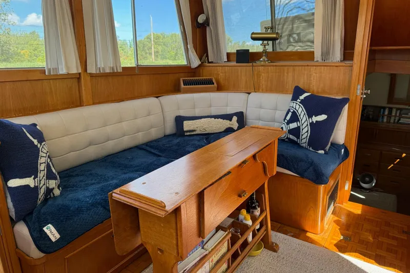 Slide: The Image of Cozy interior of 1989 Grand Banks 36 Classic with nautical-themed cushions and wooden furnishings. - 4