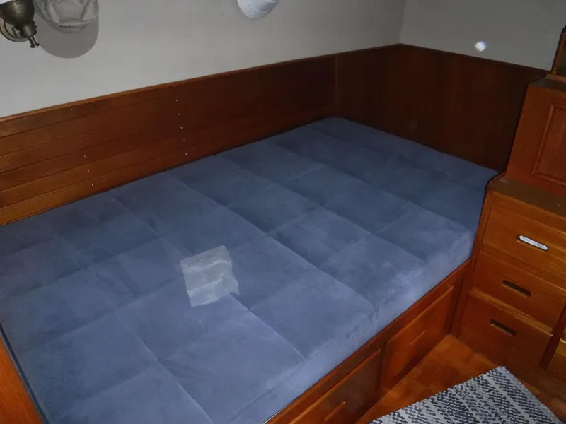 Slide: The Image of Interior of a 1989 Grand Banks 36 Classic yacht with blue mattress. - 48