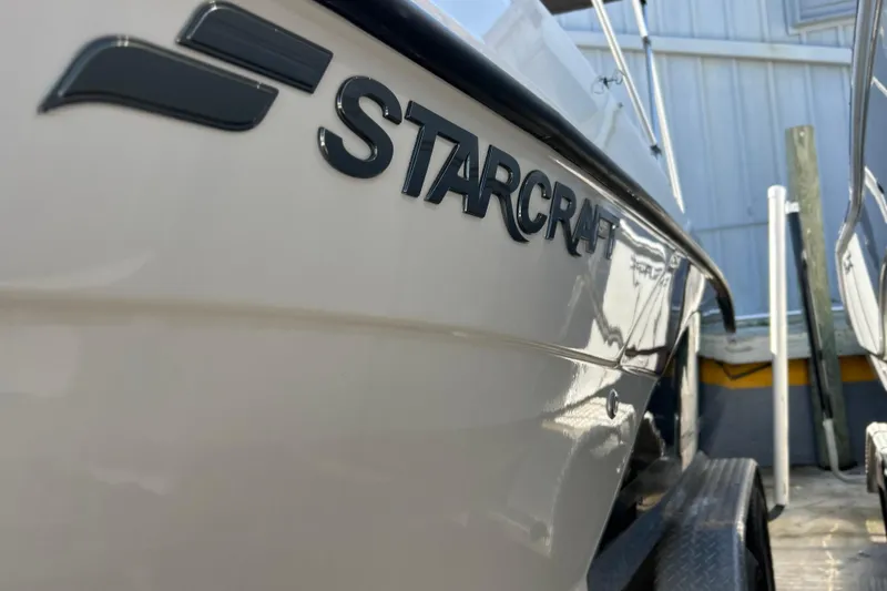 Slide: The Image of 2023 Starcraft SVX 211 IO boat side view with logo in focus. - 10