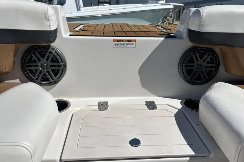 Slide: The Image of 2023 Starcraft SVX 211 IO boat interior with JL Audio speakers and cushioned seating. - 6