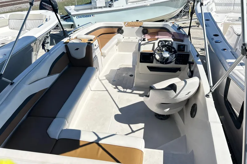 Slide: The Image of 2023 Starcraft SVX 211 IO boat interior with seating and steering console. - 8