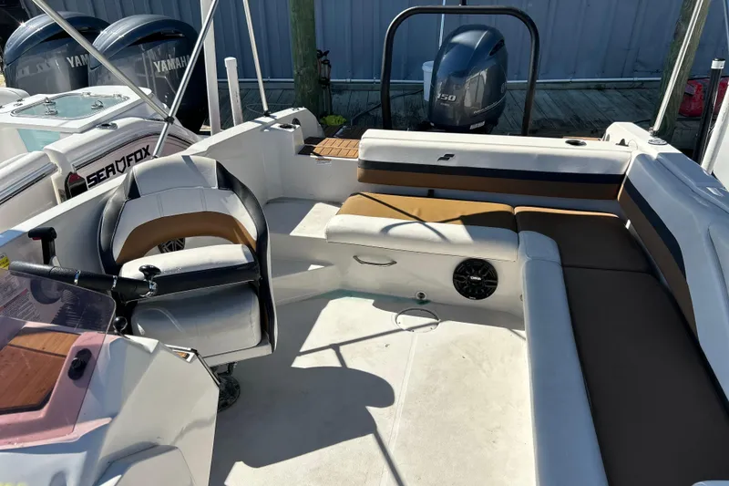 Slide: The Image of 2023 Starcraft SVX 211 IO boat interior with seating and steering wheel. - 9