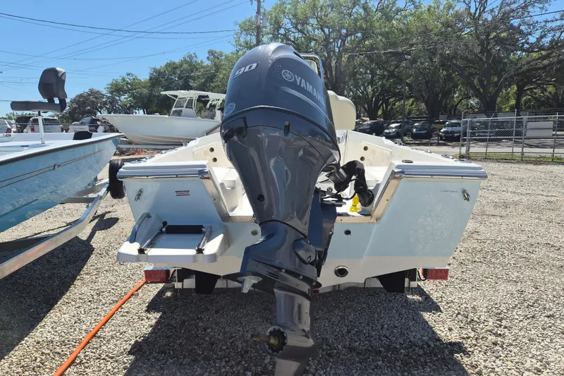 Slide: The Image of 2026 Key West 1720 Center Console boat with cushioned seating and outboard motor. - 3