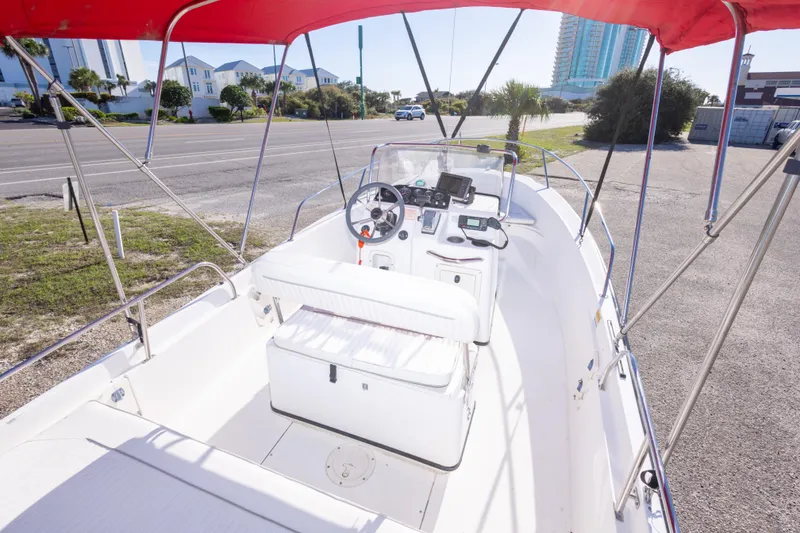 Slide: The Image of 2001 Boston Whaler 18 Dauntless boat interior with red canopy and steering console. - 11