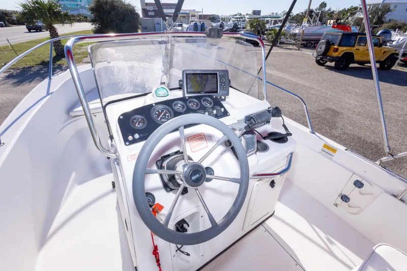 Slide: The Image of 2001 Boston Whaler 18 Dauntless boat dashboard with steering wheel and navigation equipment. - 13