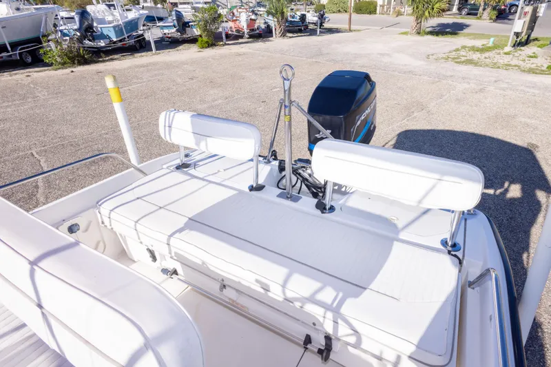 Slide: The Image of 2001 Boston Whaler 18 Dauntless boat with white seating and outboard motor. - 14