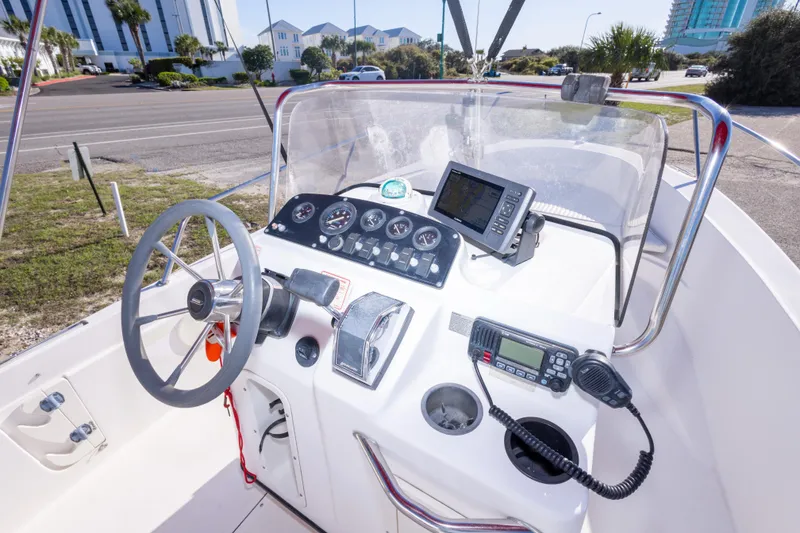 Slide: The Image of Boston Whaler 18 Dauntless 2001 boat dashboard with steering wheel and navigation equipment. - 16