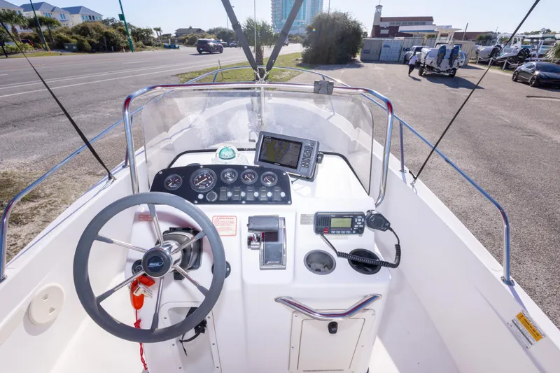 Slide: The Image of Boston Whaler 18 Dauntless 2001 boat console with steering wheel and navigation equipment. - 17