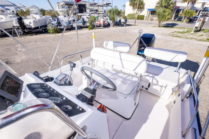 Slide: The Image of 2001 Boston Whaler 18 Dauntless boat interior with steering wheel and seating. - 18