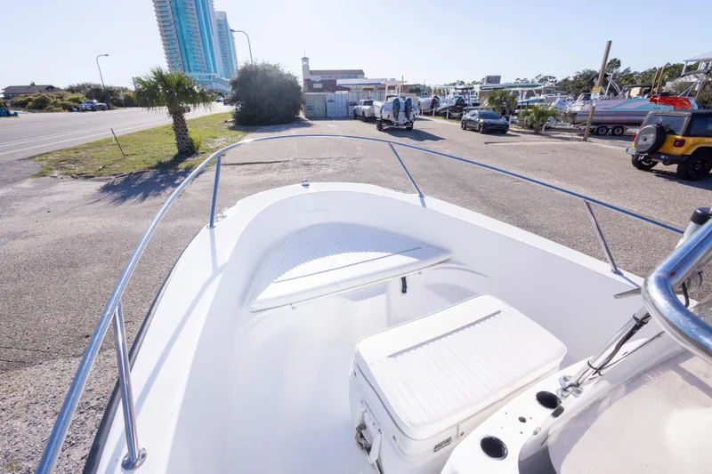 Slide: The Image of 2001 Boston Whaler 18 Dauntless boat parked near a marina with palm trees. - 19