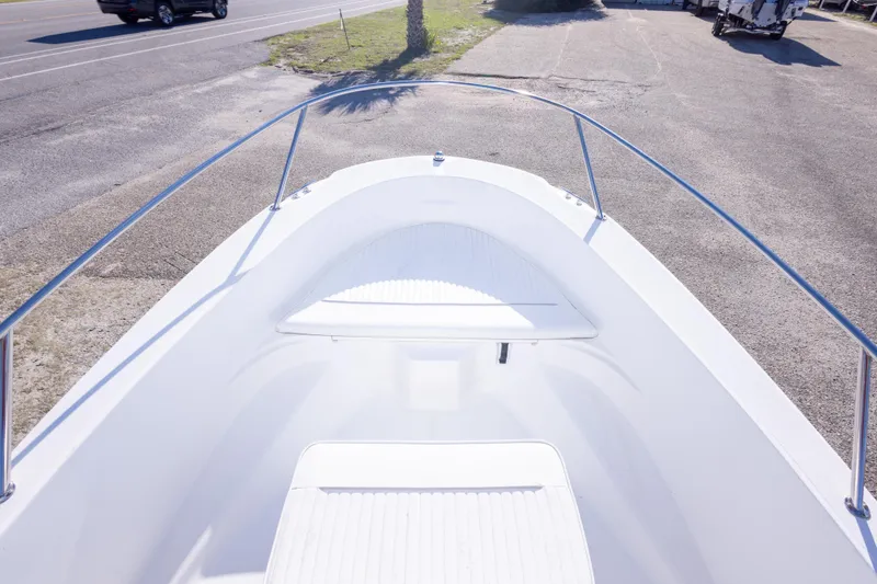 Slide: The Image of 2001 Boston Whaler 18 Dauntless boat bow view, parked on pavement near road. - 21