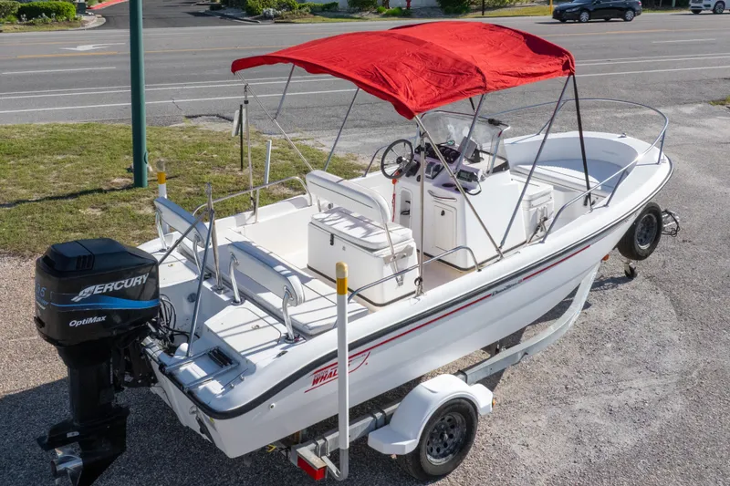 Slide: The Image of 2001 Boston Whaler 18 Dauntless boat with red canopy and Mercury outboard motor. - 28