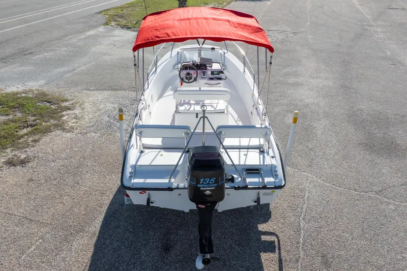 Slide: The Image of 2001 Boston Whaler 18 Dauntless boat with red canopy and Mercury 135 outboard motor. - 29