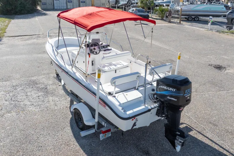 Slide: The Image of 2001 Boston Whaler 18 Dauntless boat with red canopy and Mercury 135 OptiMax engine. - 30