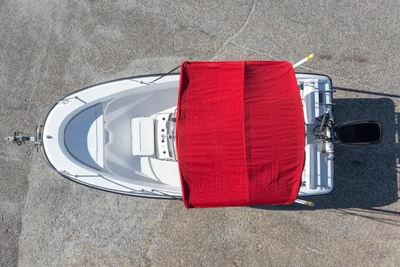 Slide: The Image of Overhead view of 2001 Boston Whaler 18 Dauntless boat with red cover. - 34