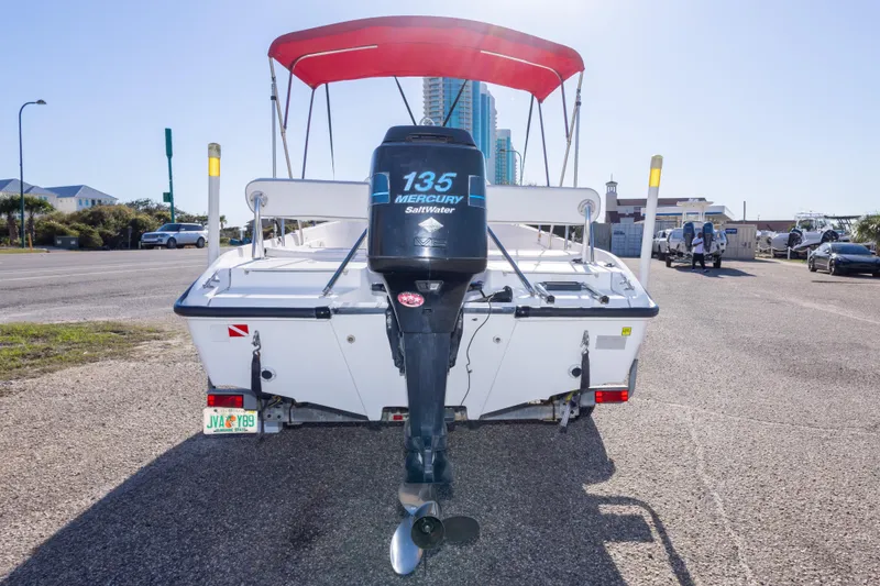 Slide: The Image of 2001 Boston Whaler 18 Dauntless boat with Mercury 135 outboard motor and red canopy. - 5