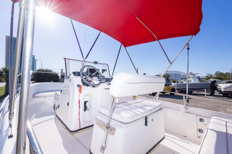 Slide: The Image of 2001 Boston Whaler 18 Dauntless boat with red canopy and steering console. - 9