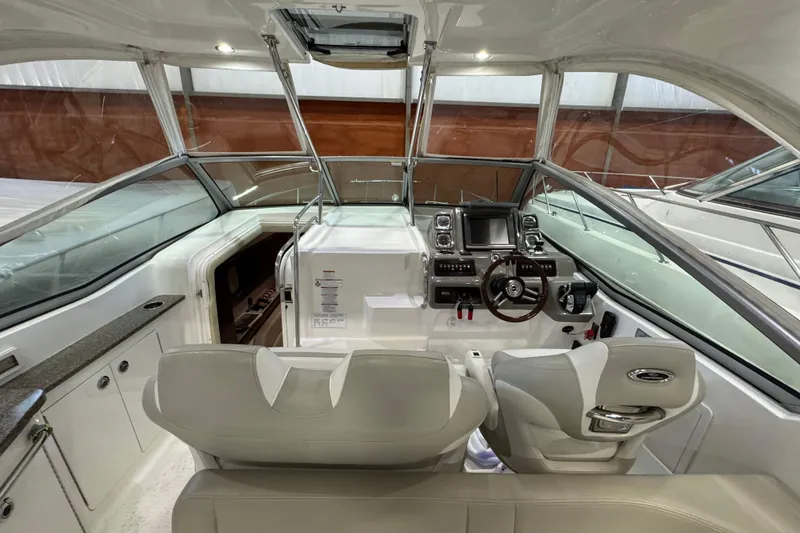 Slide: The Image of 2015 Chaparral 330 Signature boat cockpit with modern controls and seating. - 10
