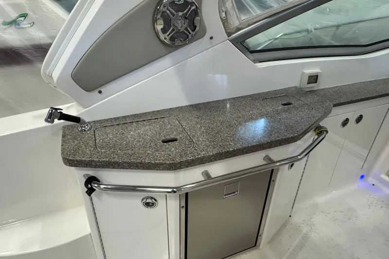 Slide: The Image of 2015 Chaparral 330 Signature boat interior with granite countertop and built-in sink. - 11
