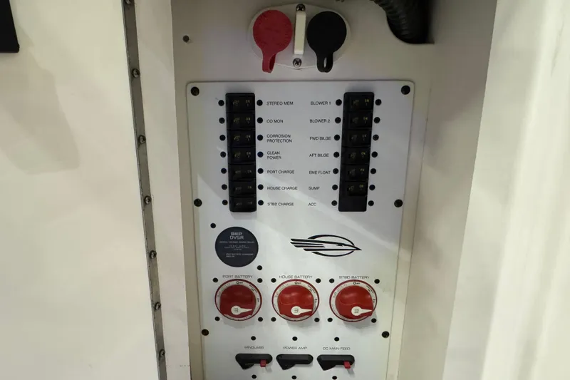 Slide: The Image of Control panel of a 2015 Chaparral 330 Signature boat with switches and battery controls. - 13