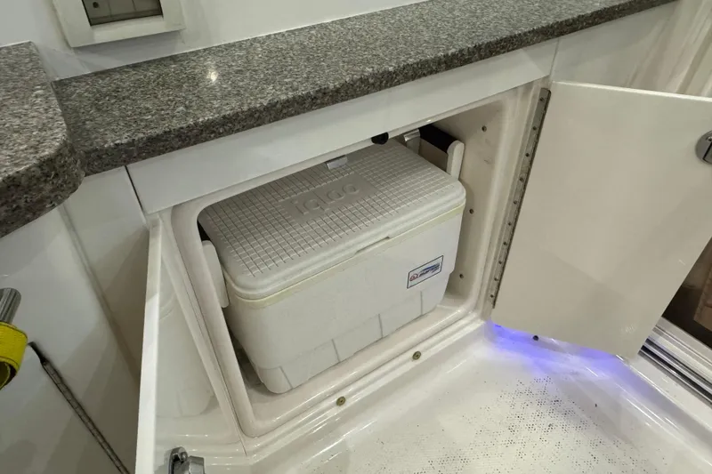 Slide: The Image of 2015 Chaparral 330 Signature boat with built-in cooler storage under granite countertop. - 14