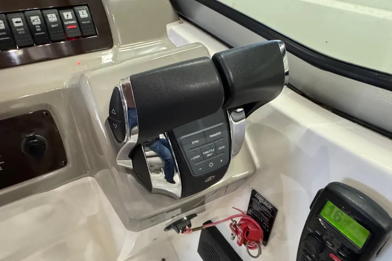 Slide: The Image of Control panel of a 2015 Chaparral 330 Signature boat with throttle levers. - 17
