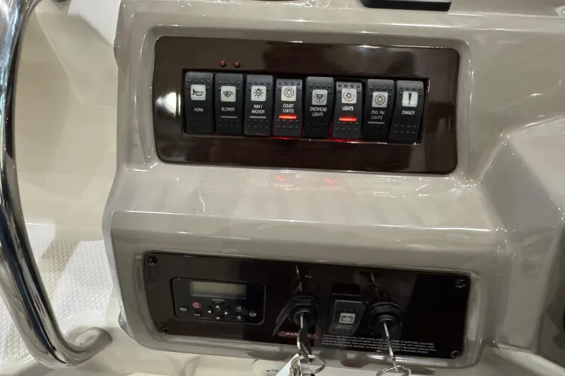 Slide: The Image of Control panel of a 2015 Chaparral 330 Signature boat with labeled switches. - 18