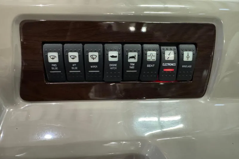 Slide: The Image of Control panel of a 2015 Chaparral 330 Signature boat with labeled switches. - 19