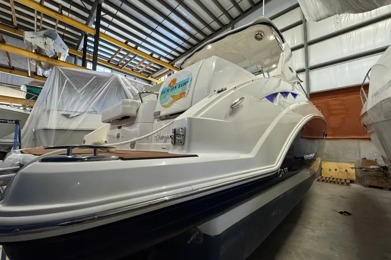 Slide: The Image of 2015 Chaparral 330 Signature boat in storage, showcasing sleek design and modern features. - 2