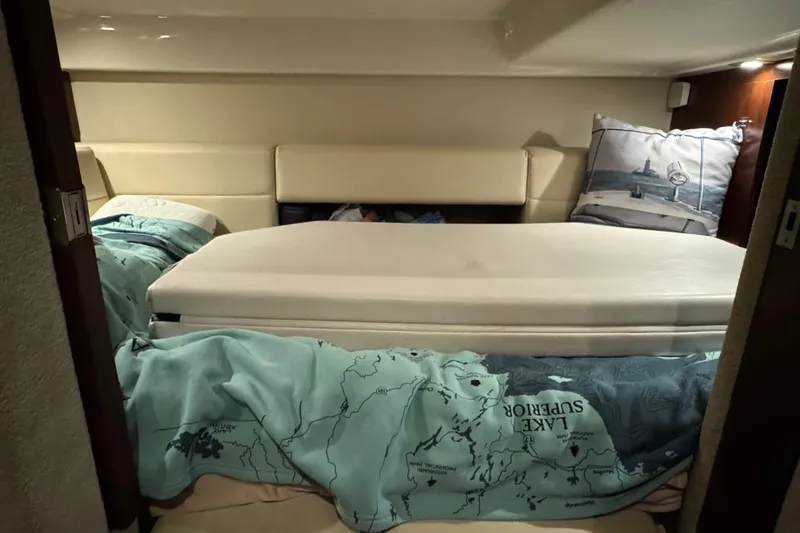 Slide: The Image of Cozy cabin interior of 2015 Chaparral 330 Signature with nautical-themed bedding. - 30