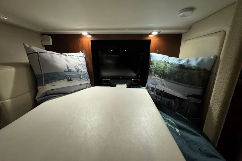 Slide: The Image of Cozy cabin interior of 2015 Chaparral 330 Signature with decorative pillows and ambient lighting. - 32