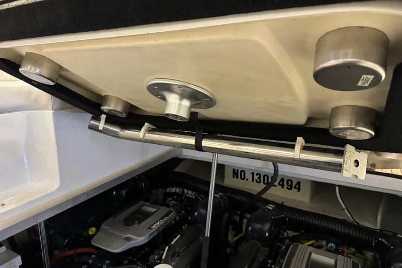 Slide: The Image of Engine compartment of a 2015 Chaparral 330 Signature boat, showcasing mechanical components. - 34