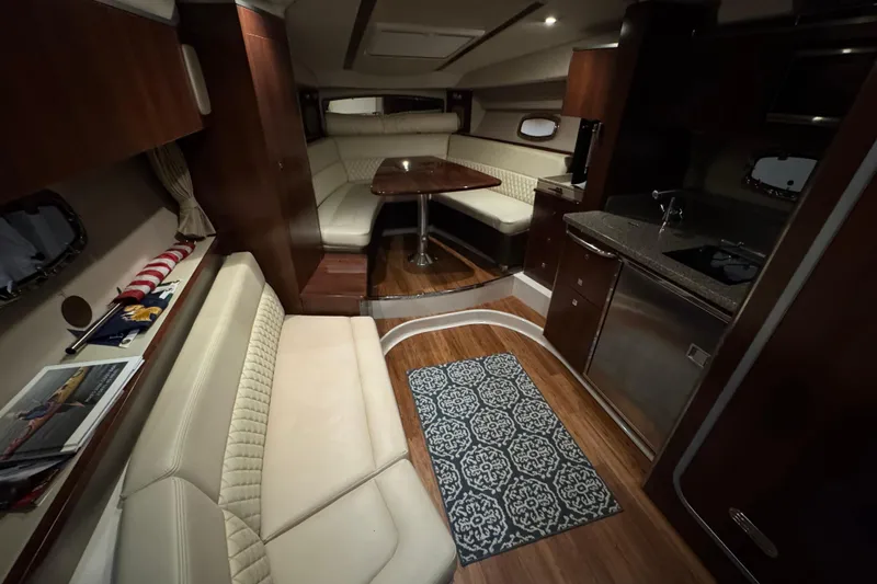 Slide: The Image of Cozy cabin interior of 2015 Chaparral 330 Signature with nautical-themed bedding. - 38