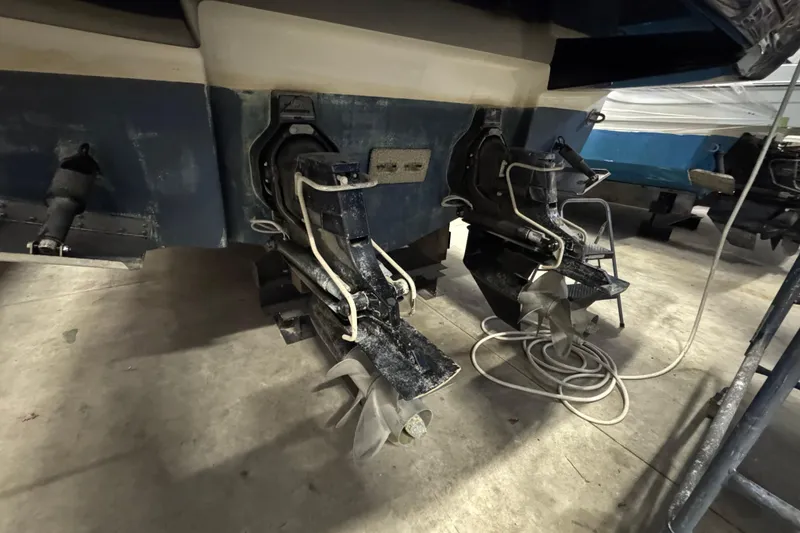 Slide: The Image of 2015 Chaparral 330 Signature boat stern with dual propellers in a storage area. - 4